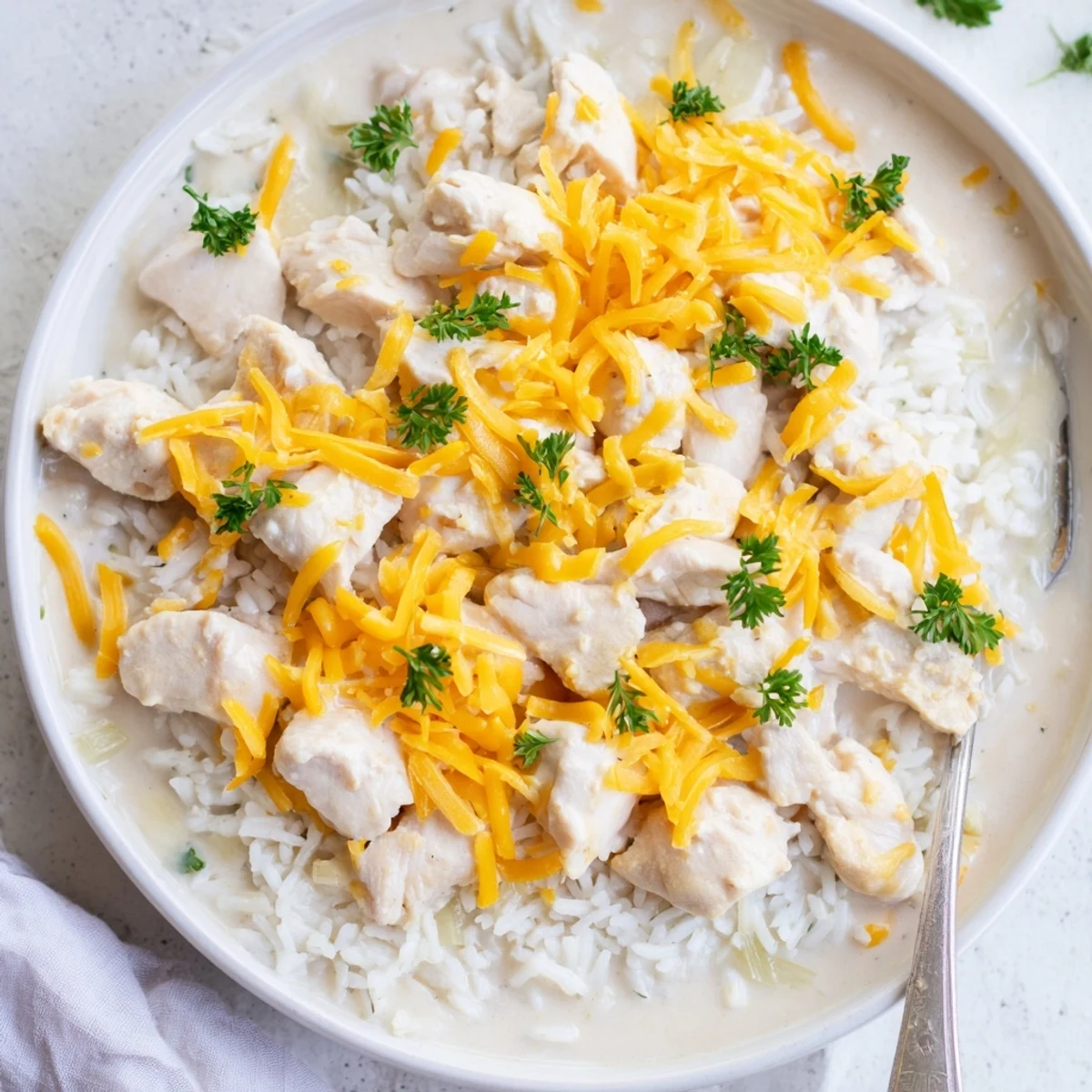 One-pan smothered chicken and rice bubbling with rich cream sauce and perfectly tender grains
