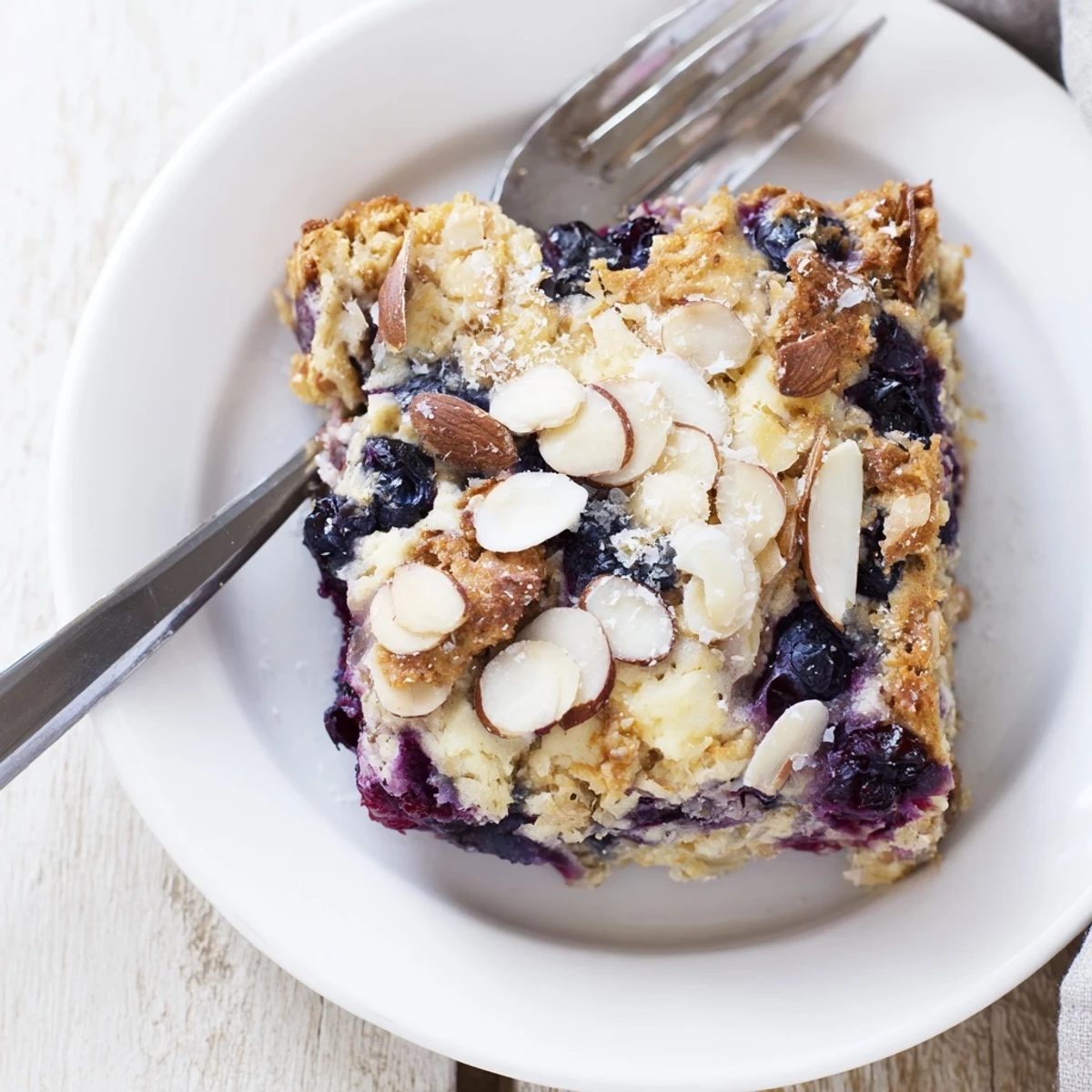 Sliced blueberry cottage cheese breakfast bake served fresh from the oven with berries