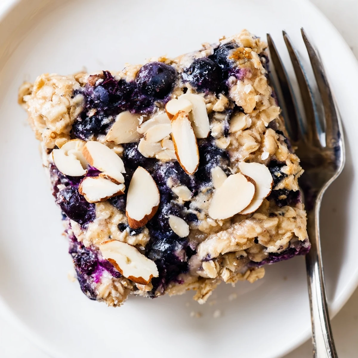 Warm blueberry cottage cheese breakfast bake topped with almonds and coarse sugar
