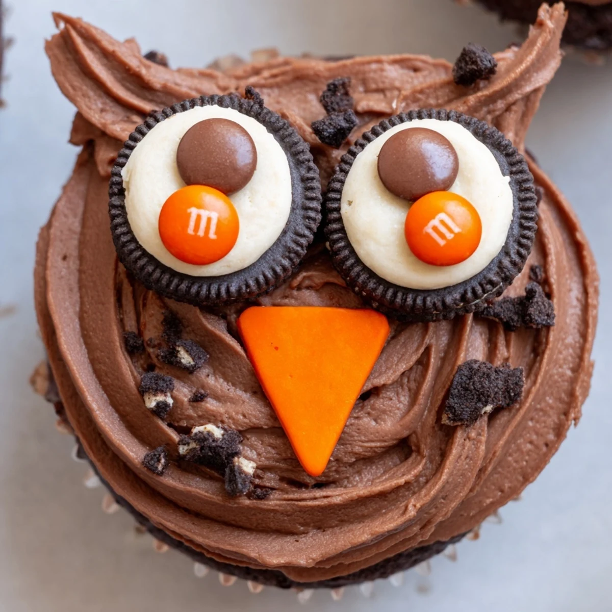 Charming Oreo Owl Cupcakes with chocolate frosting and candy eyes on display