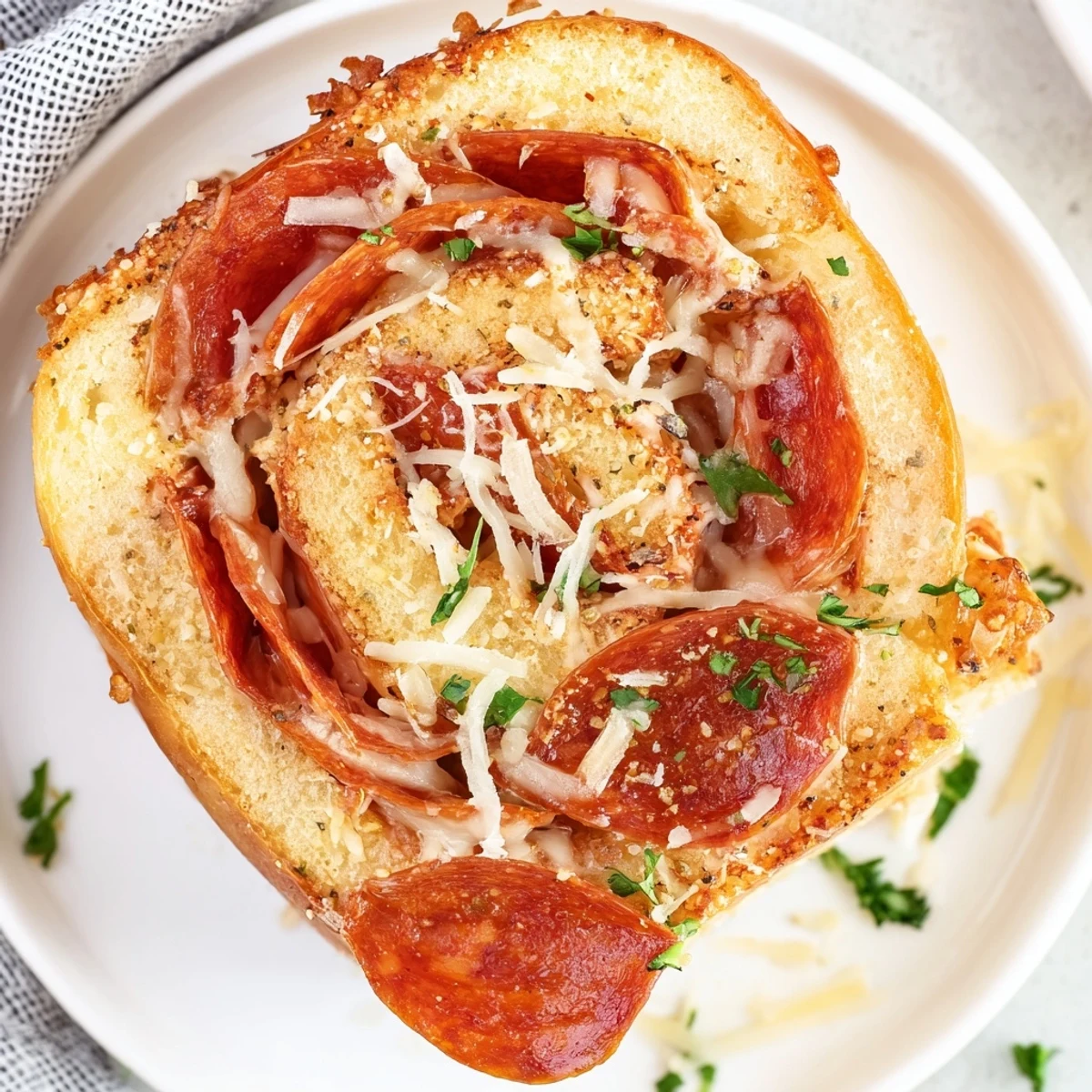 Warm pepperoni pizza roll breadsticks served with marinara sauce for gameday dipping