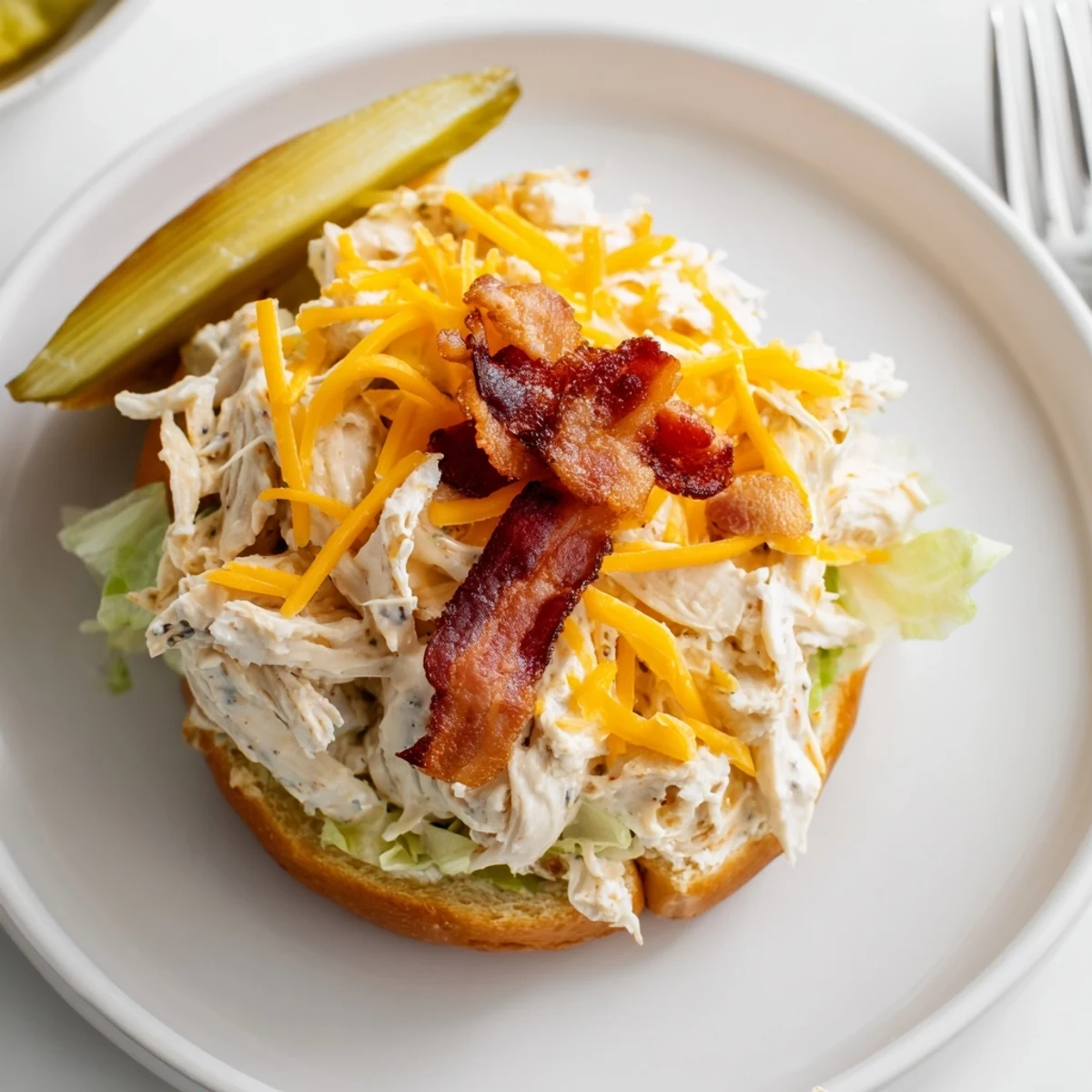 Crowd-pleasing Crack Chicken Sandwiches, melty cream cheese filling spooned onto toasted buns.