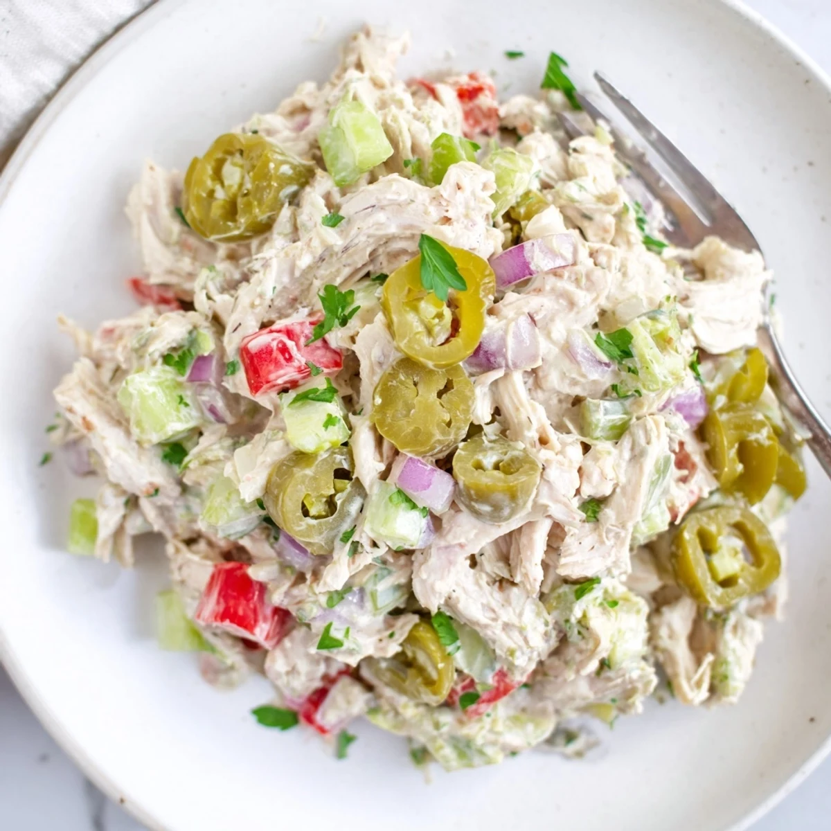 Bright, zesty High Protein Pepperoncini Chicken Salad served chilled on mixed greens.  