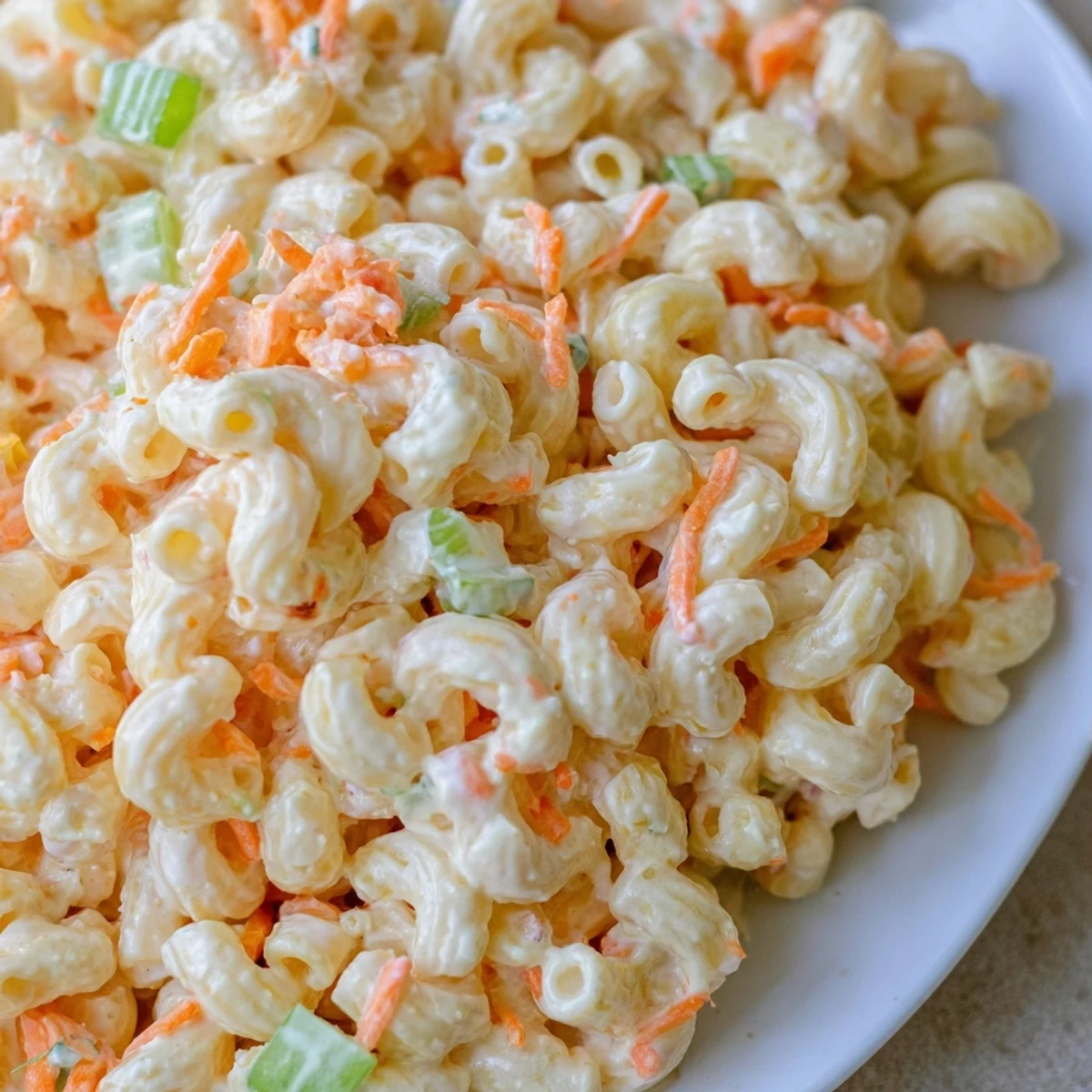 Classic Hawaiian style mac salad with finely chopped vegetables ready for a summer plate lunch gathering