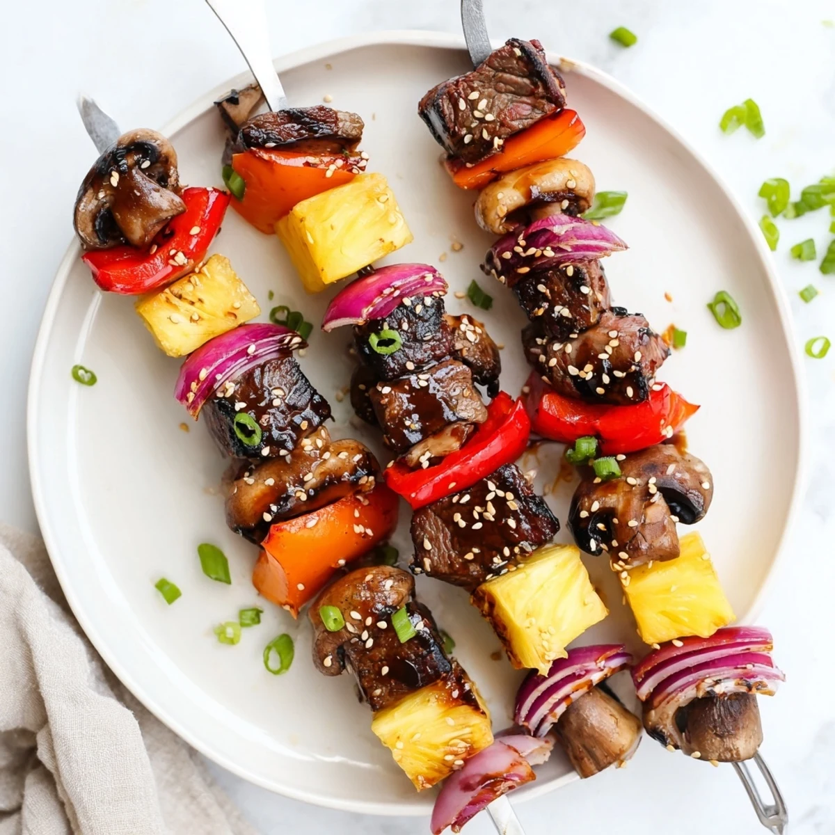Juicy Grilled Teriyaki Steak Kabobs served hot over steamed jasmine rice.