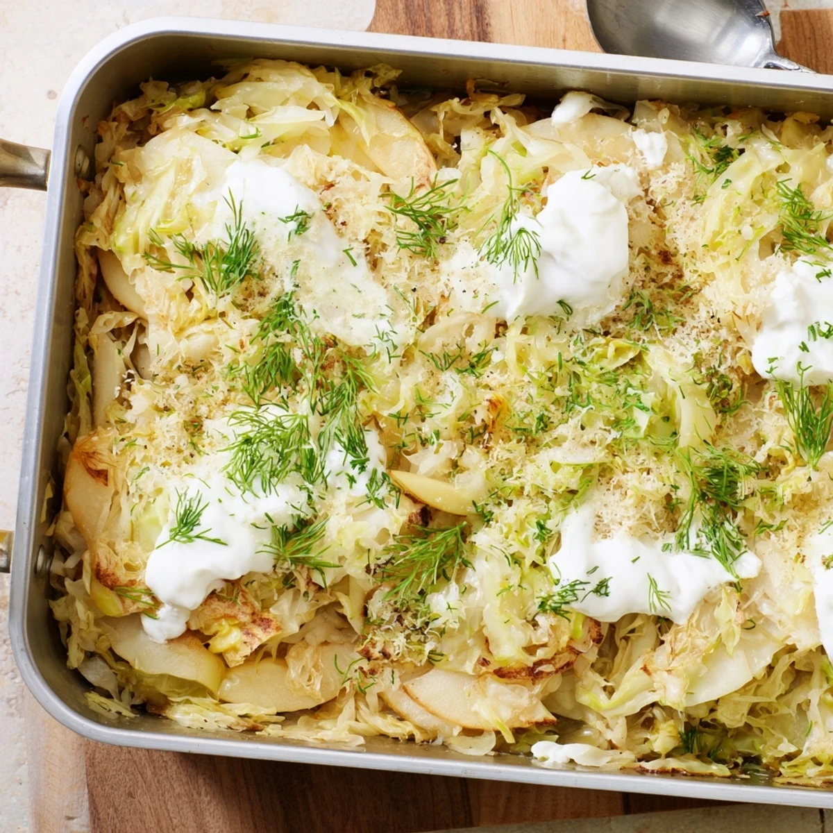 Hearty German-style cabbage casserole with tender roasted layers and tangy sauerkraut, topped with creamy sour cream