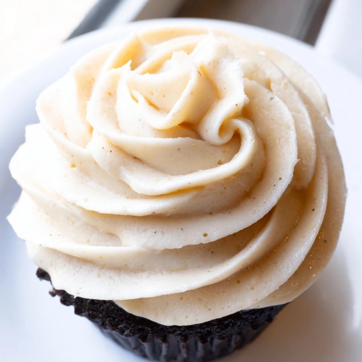Fluffy Italian meringue buttercream swirled atop a golden layer cake