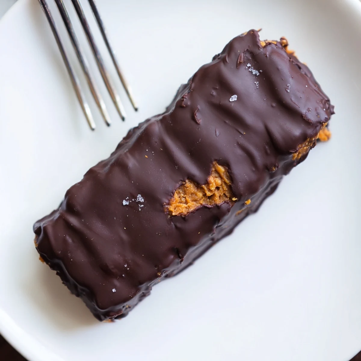 Golden peanut butter and corn flake bars coated in smooth dark chocolate chunks